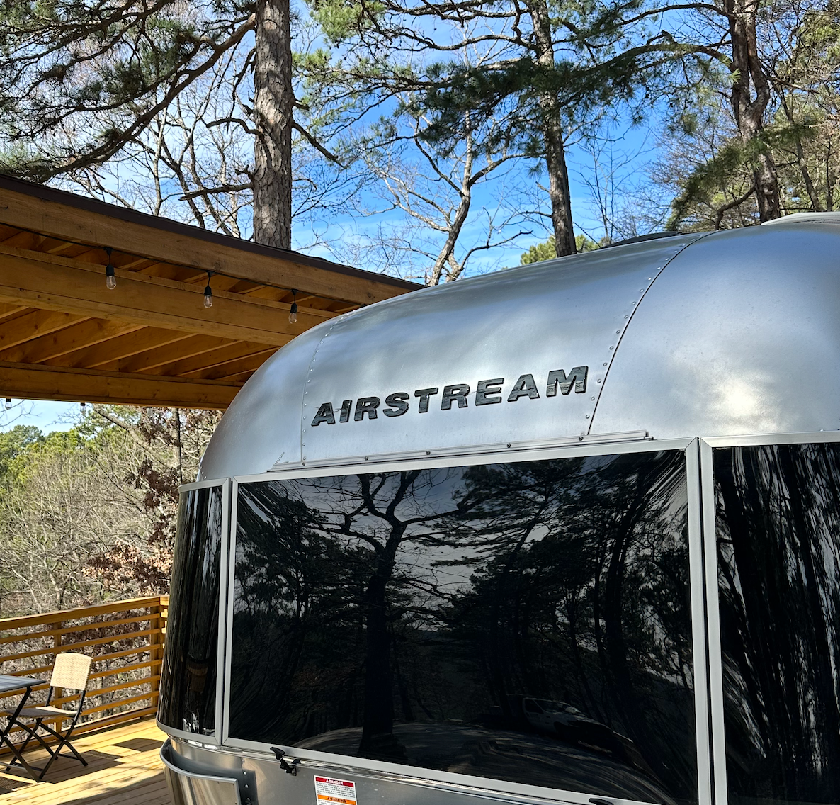 Airstream trailer surrounded by autumn fall foliage at Loblolly Pines Adventure Camp